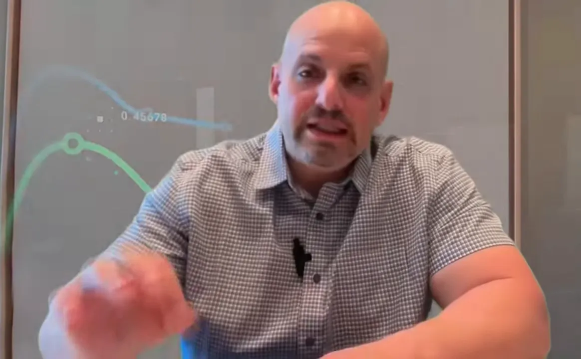 Presenter explaining lender matching with faint overlay charts visible on the screen.