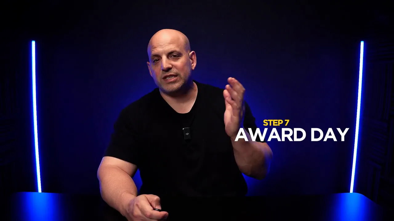 Presenter in a studio with on-screen text 'STEP 7 AWARD DAY' indicating the award day step.