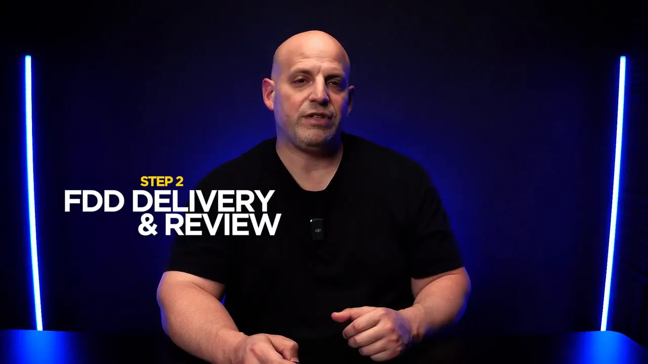 Speaker in blue-lit studio with on-screen text 'STEP 2 FDD DELIVERY & REVIEW'