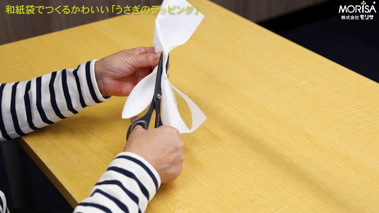 上部を折りたたんで耳の形に切り込む場面