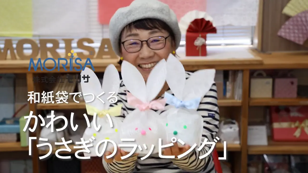 ここくる先生の挨拶、完成したうさぎバッグを見せる様子