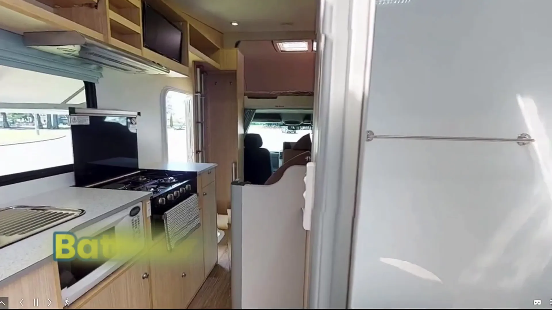 Spacious motorhome interior showing kitchen and dining area
