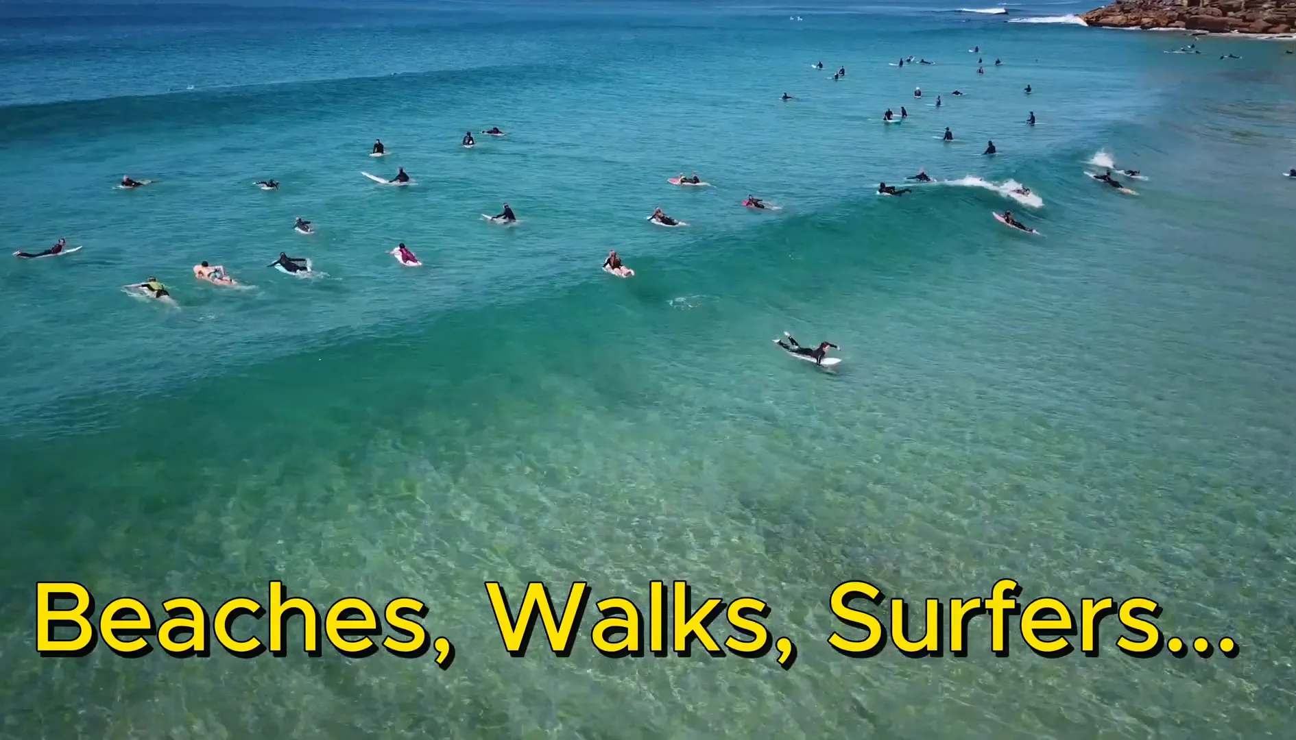 Manly Beach with surfers and golden sand