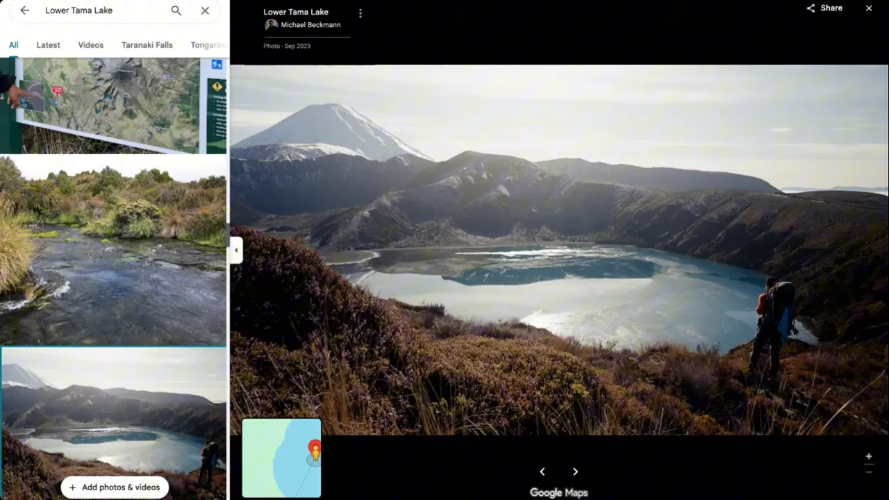 Panoramic view into a crater lake with Mount Ruapehu in the background and a hiker standing on the rim.
