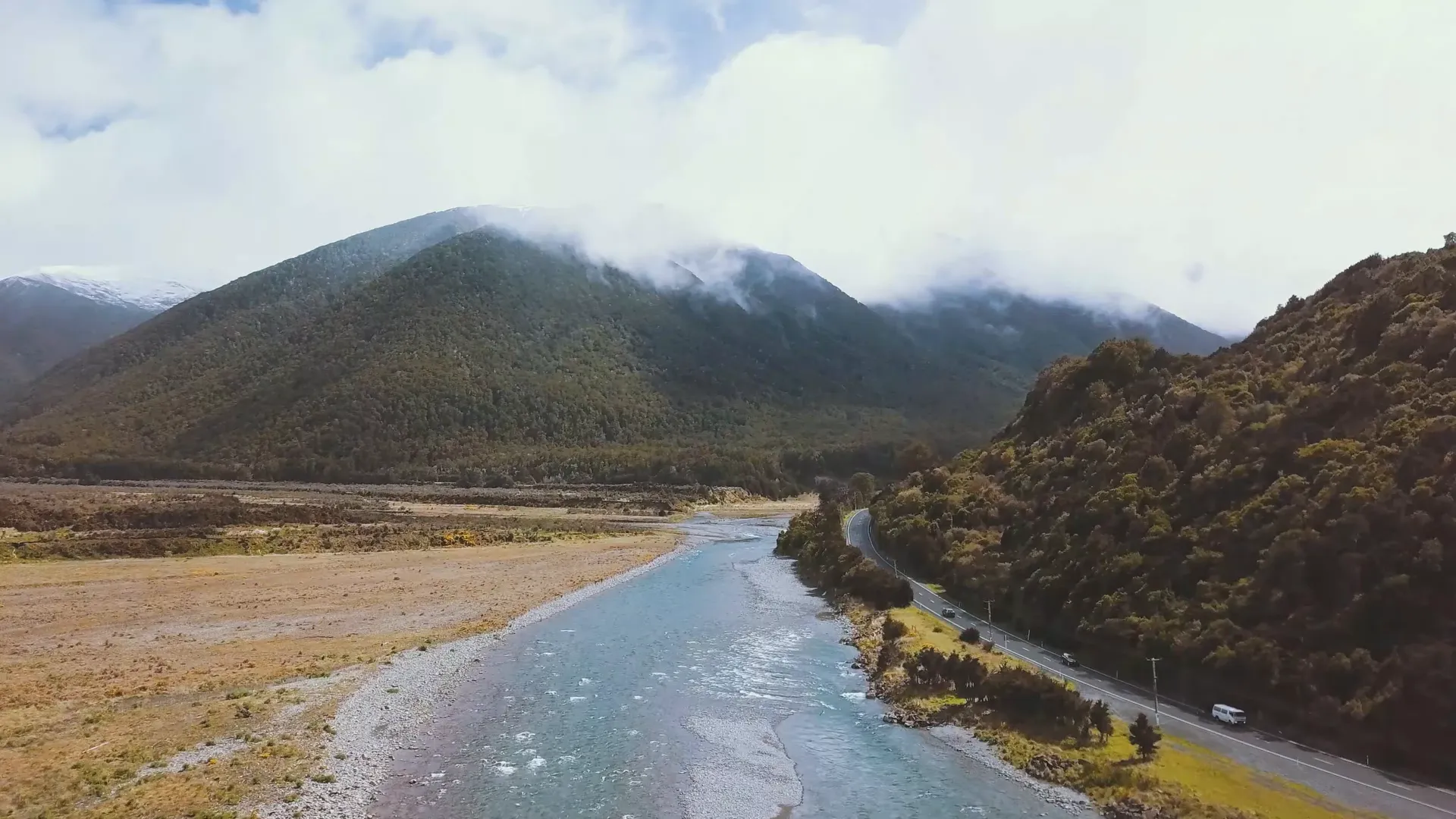 Mid-size SUV on a scenic drive through New Zealand hills