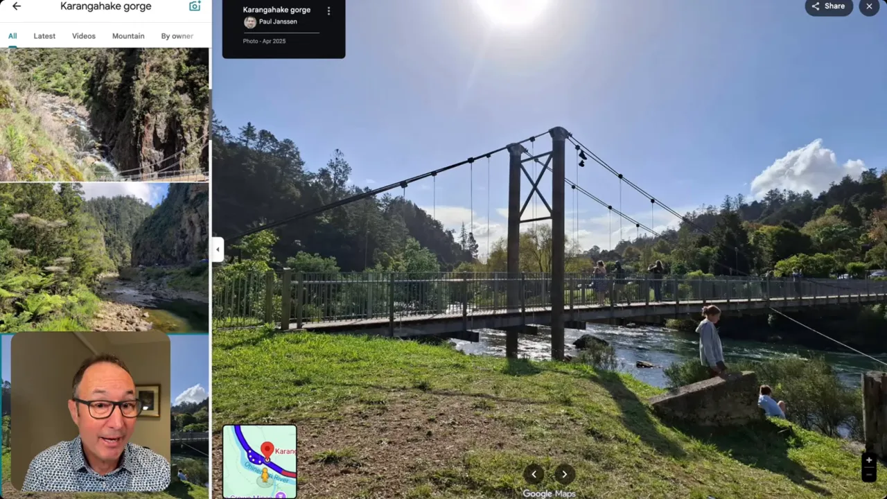 Karangahake Gorge suspension bridge over the river with grassy riverbank and walkers