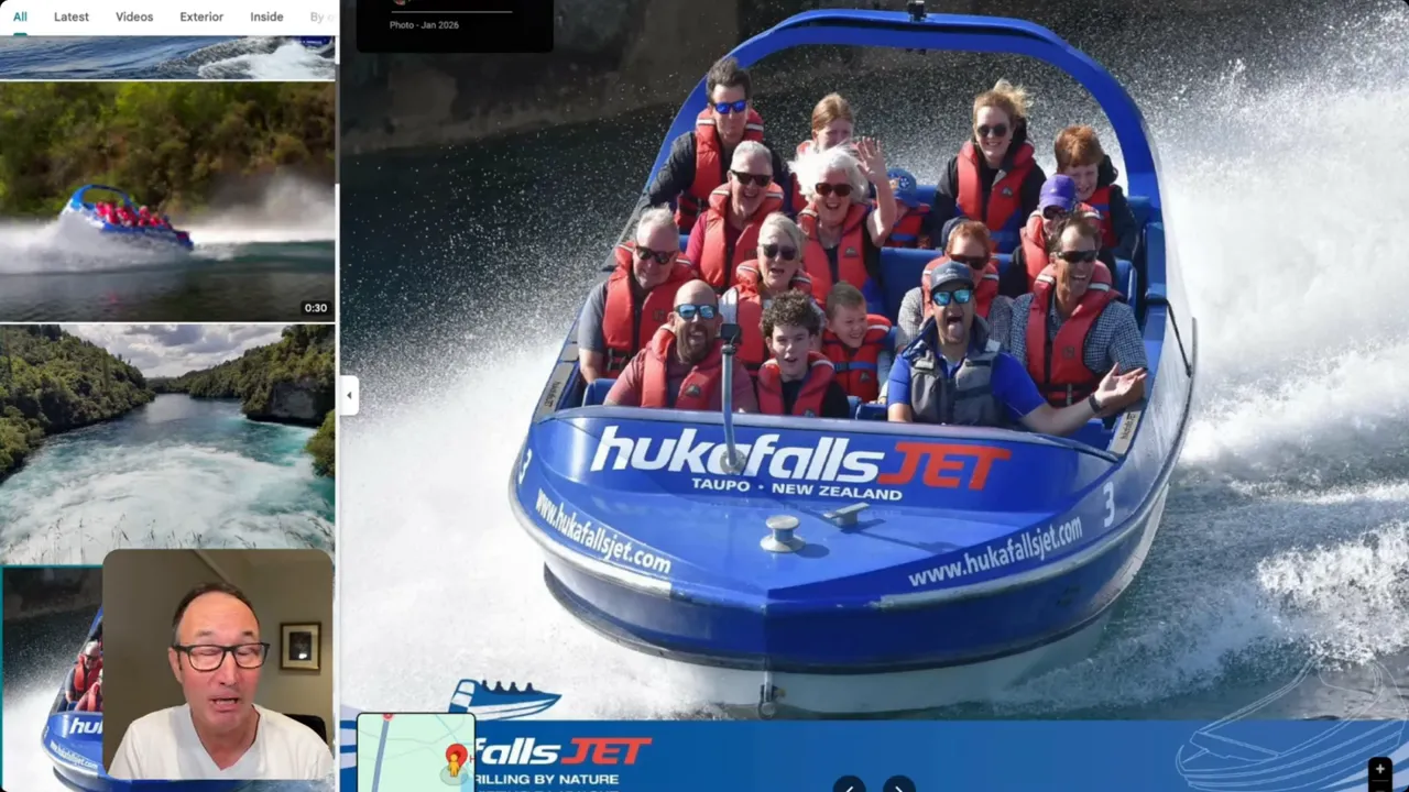 Close-up of a Huka Falls Jet boat full of passengers powering through the water with spray around it.