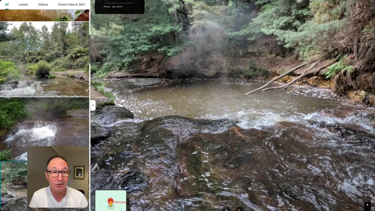 View from the creek edge across a steaming pool and rocky ledge at Kerosene Creek