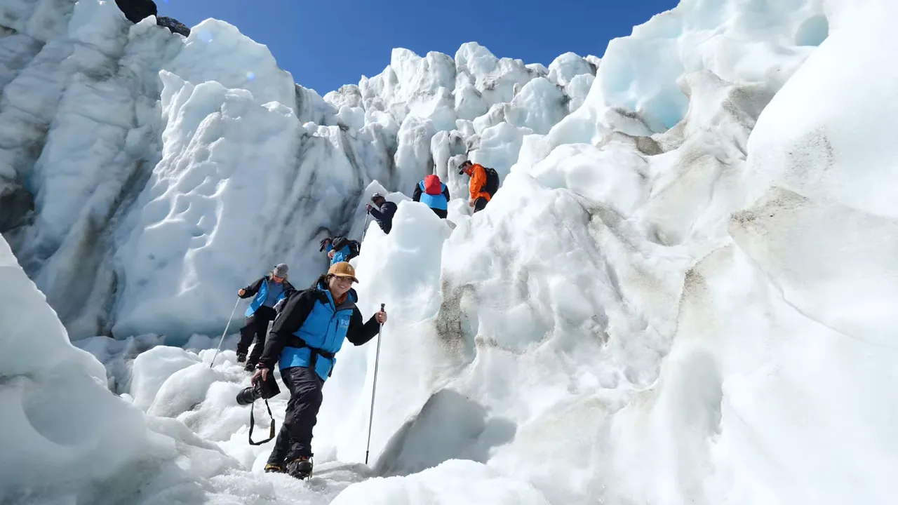 Participants gearing up for a heli-hike with crampons and guide on the glacier