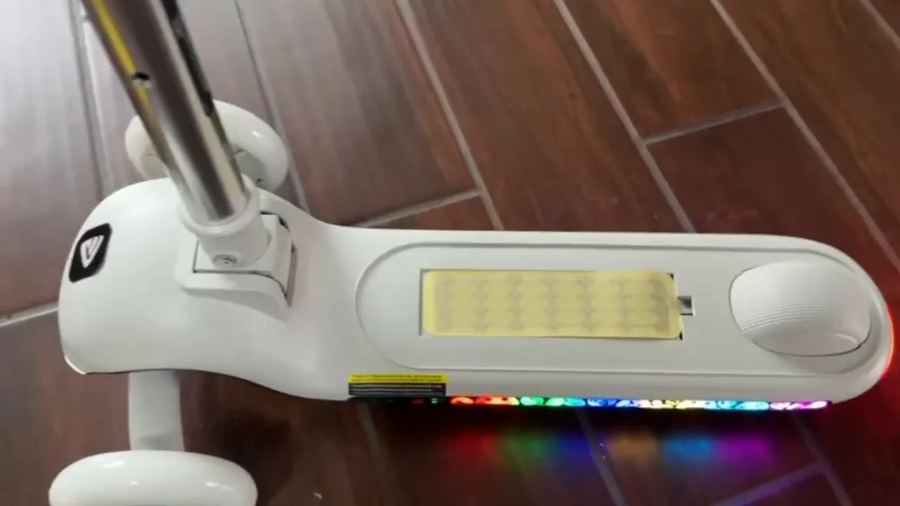 Fantic Ride K9 Pro scooter deck and controls with glowing rainbow LED strip indoors