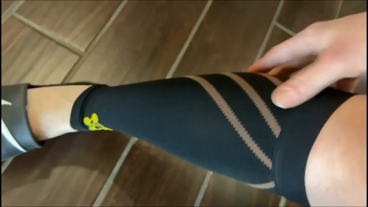 Copper infused calf sleeve being adjusted to show stretch and fit