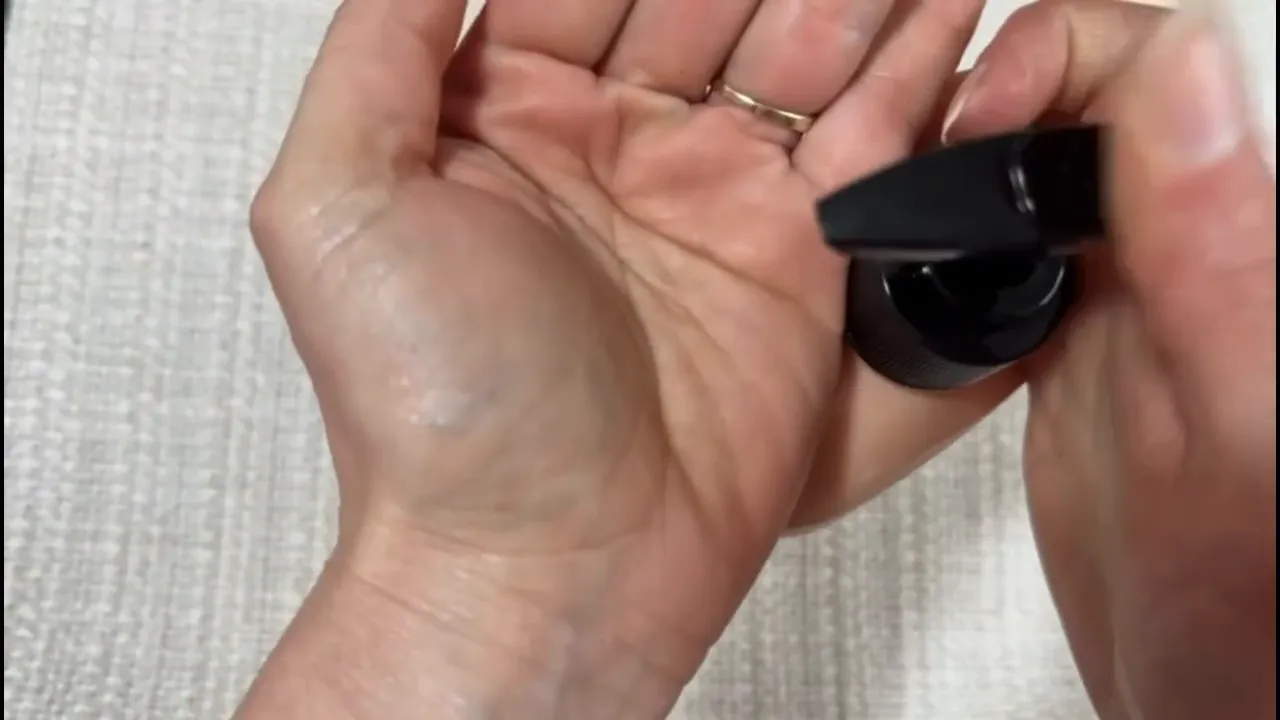 Close-up of hands applying Hempz Juicy Peach body lotion for smooth absorption