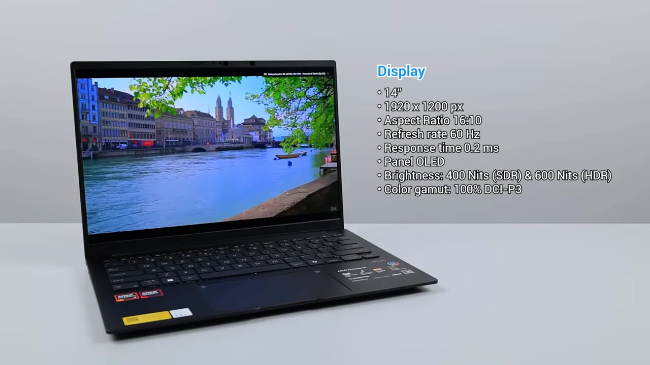 ASUS Zenbook 14 OLED menampilkan pemandangan kota di layar serta daftar spesifikasi layar
