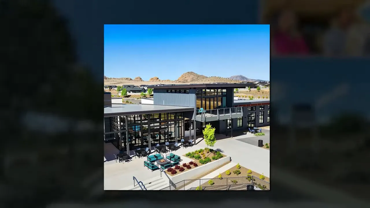 Modern clubhouse building with outdoor seating, patios and landscaped forecourt at a master-planned community.