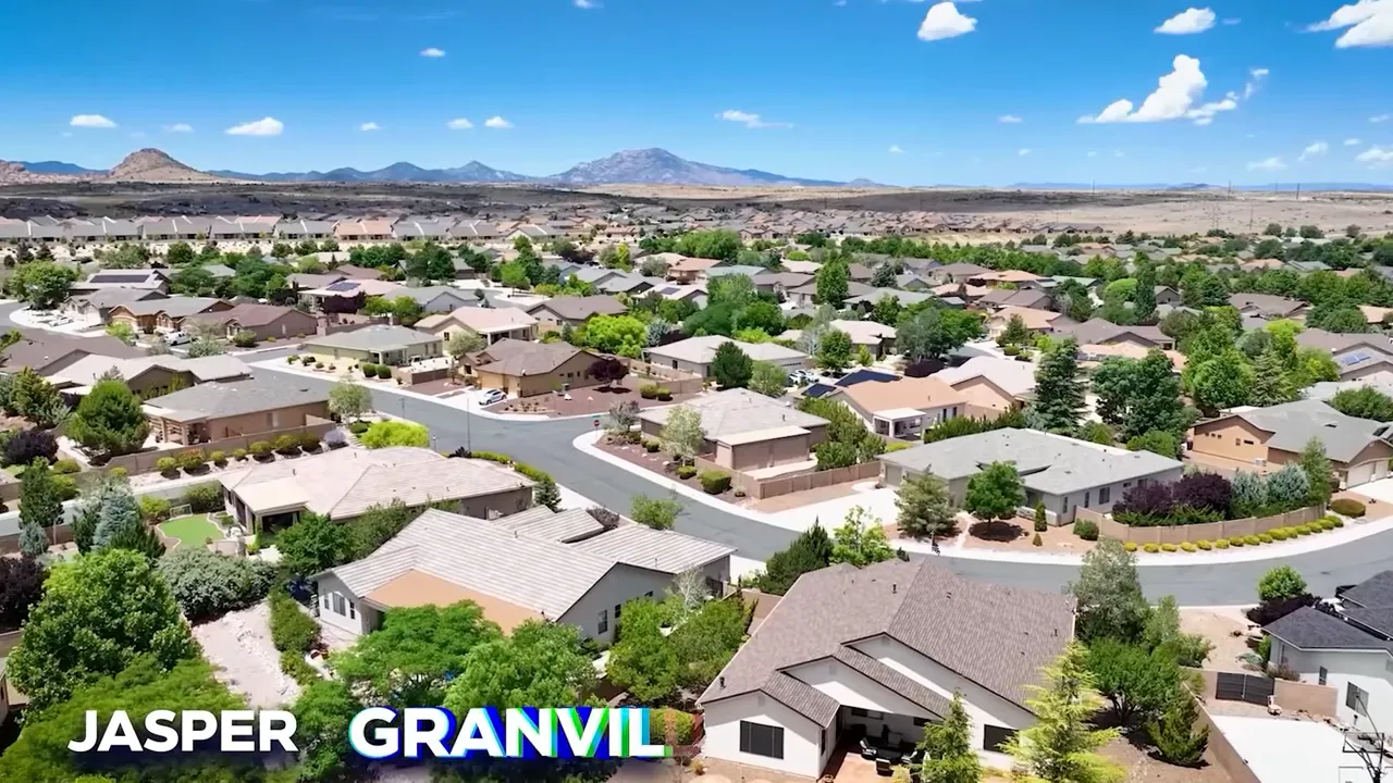 Wide aerial view of a Jasper/Granville master‑plan neighborhood with single‑story homes, trees, and distant mountains