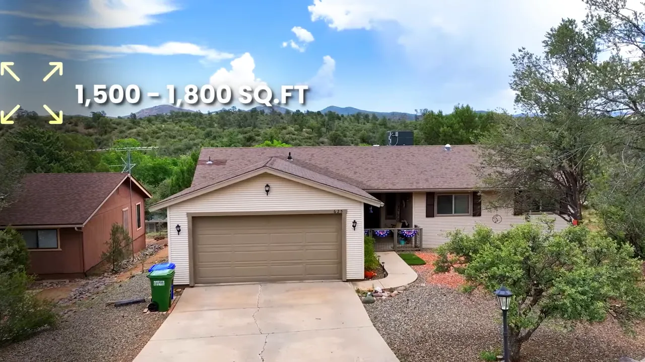 Ranch‑style home with two‑car garage surrounded by pines and overlaid text '1,500–1,800 SQ.FT'