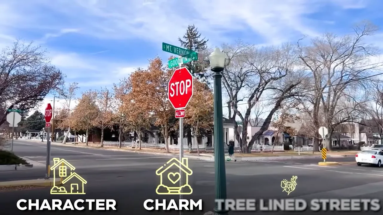Stop sign with South Mt. Vernon street sign at a tree-lined downtown Prescott intersection with historic houses in the background.
