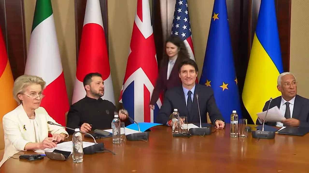 Officials seated at an international summit table with multiple national flags and EU symbolism behind them