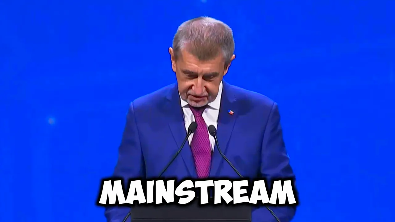 Politician at a lectern looking down with large 'MAINSTREAM' text overlaid on a blue stage background