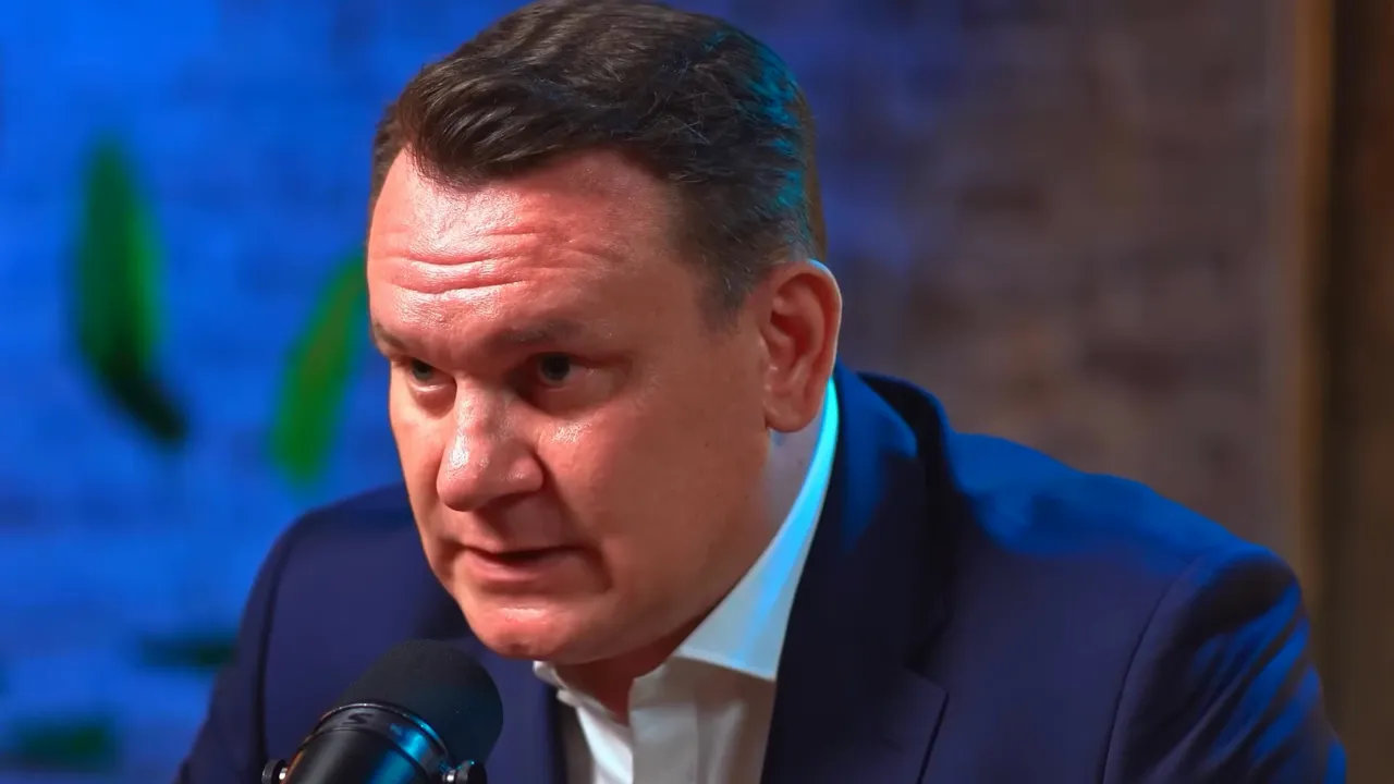 closeup of a speaker speaking into a microphone with serious expression