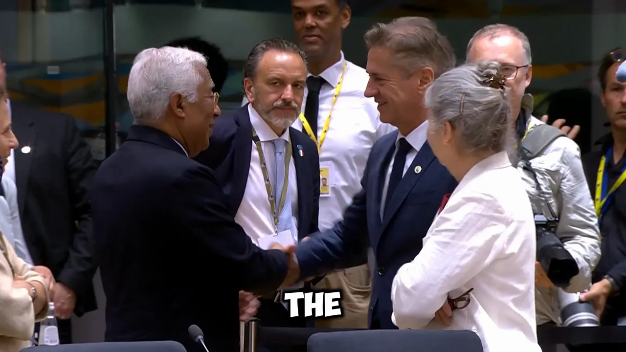 Two leaders shaking hands in a corridor outside a meeting while others and photographers look on.