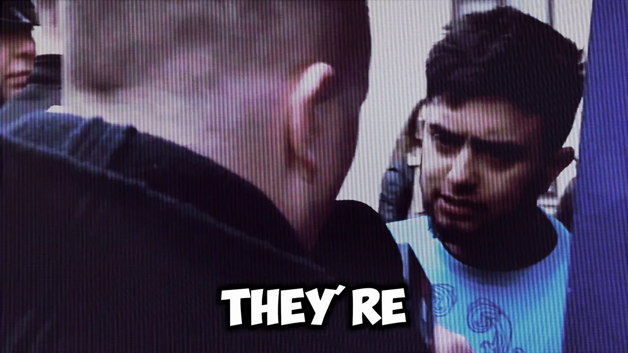 Two men in a tense street exchange, captured from on-scene footage with the overlaid words 'THEY'RE'.