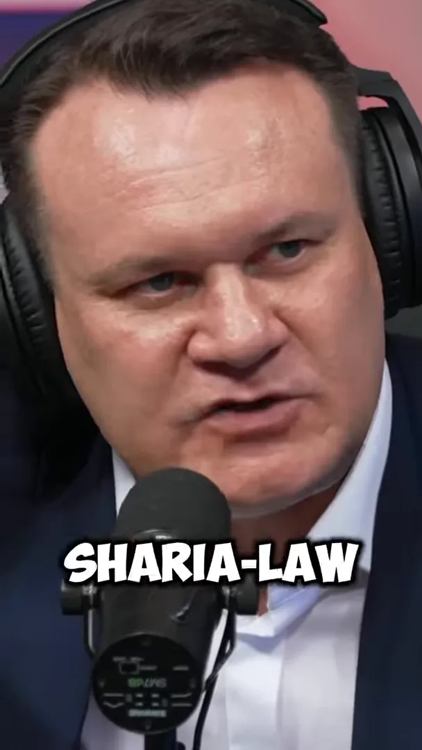 Dominik Tarczyński speaking into a microphone with on-screen text saying “SHARIA-LAW”