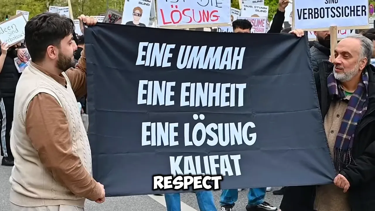 Black protest banner reading eine ummah eine einheit eine lösung kalifat held by two men