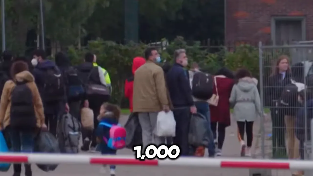 Group of people standing outdoors with luggage near a barrier
