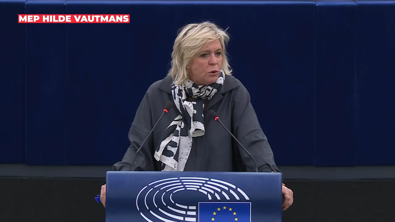 Speaker at a parliamentary podium gesturing while addressing the chamber; clear view of the EU emblem on the lectern.