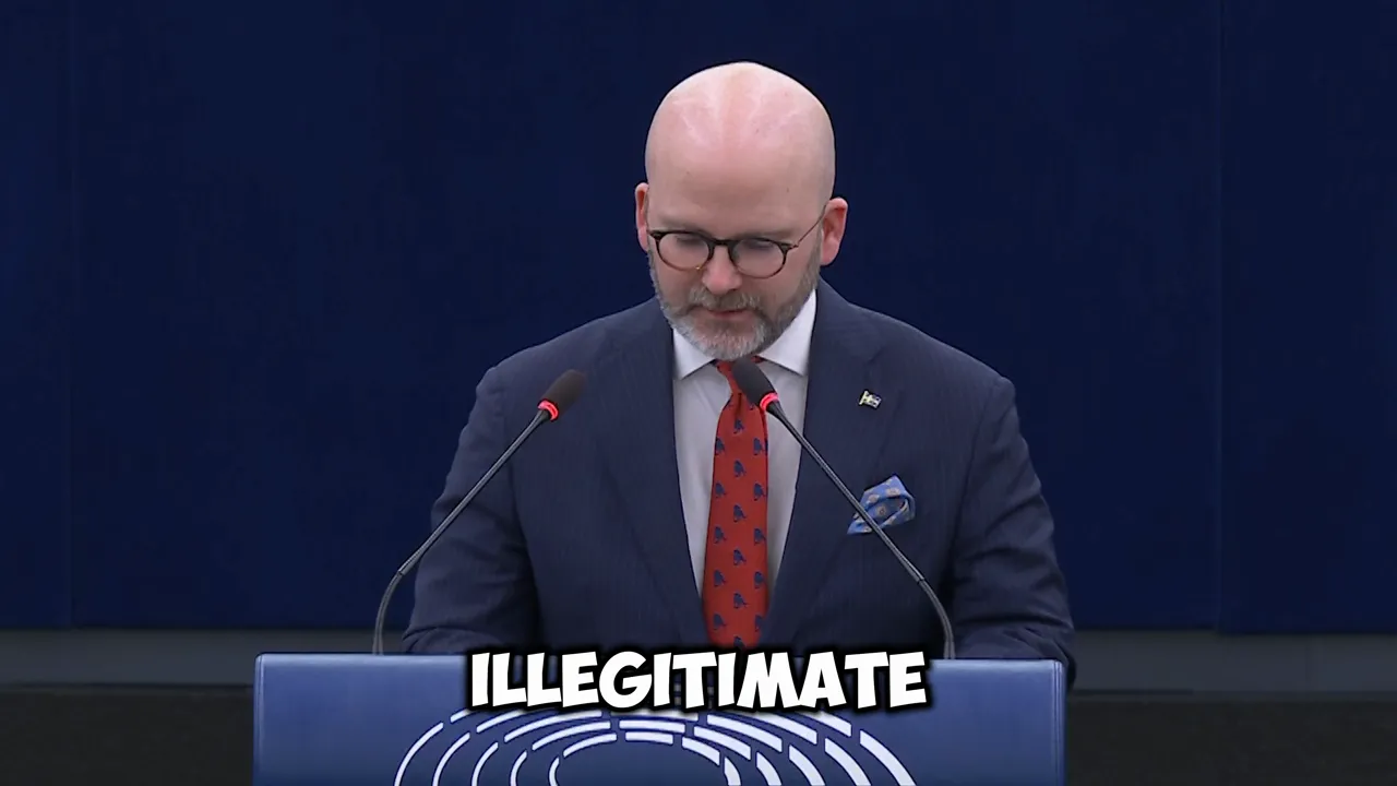 Close shot of a speaker at an EU podium with two microphones and bold overlay text reading 'ILLEGITIMATE'