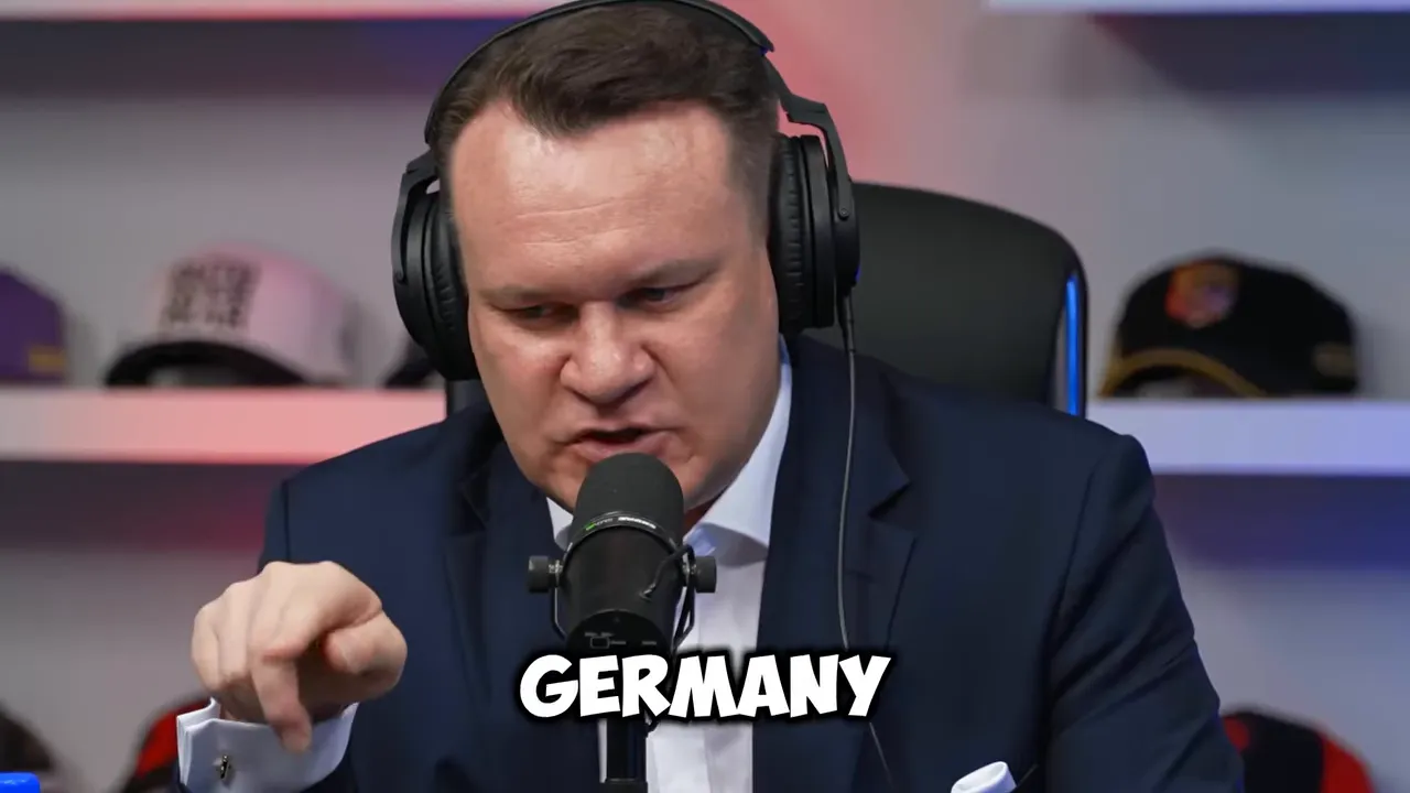 Dominik Tarczyński gesturing while speaking into a microphone in a studio