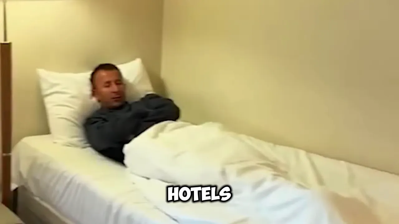 Man lying on a bed in a plain hotel room