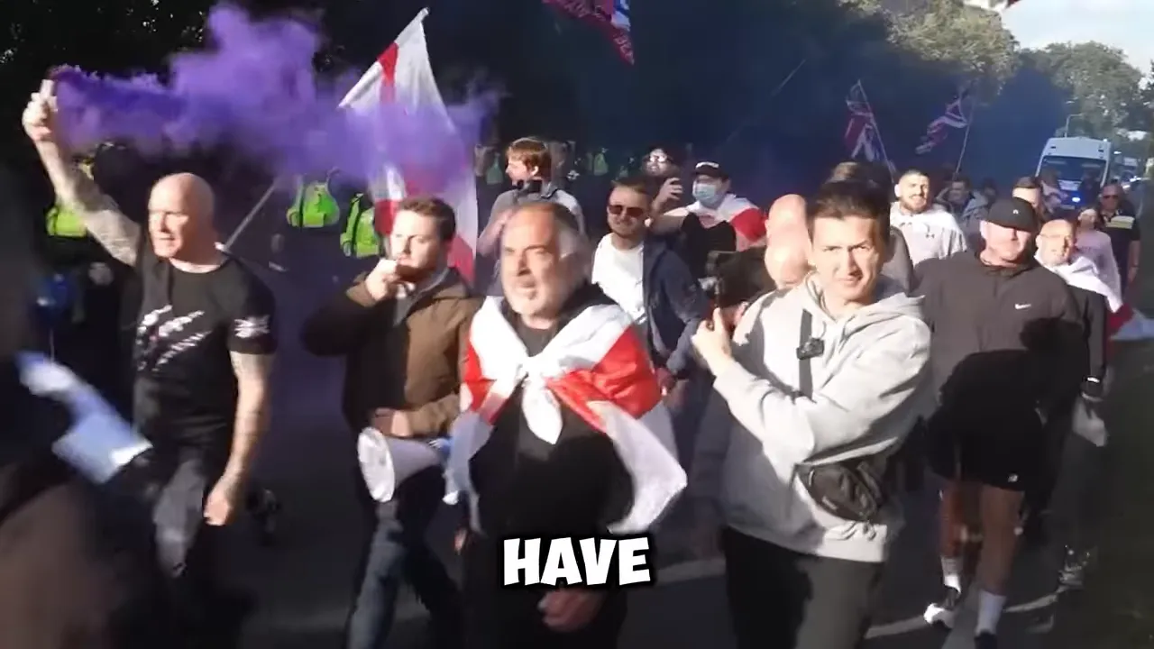 Marchers carrying England flags along a road