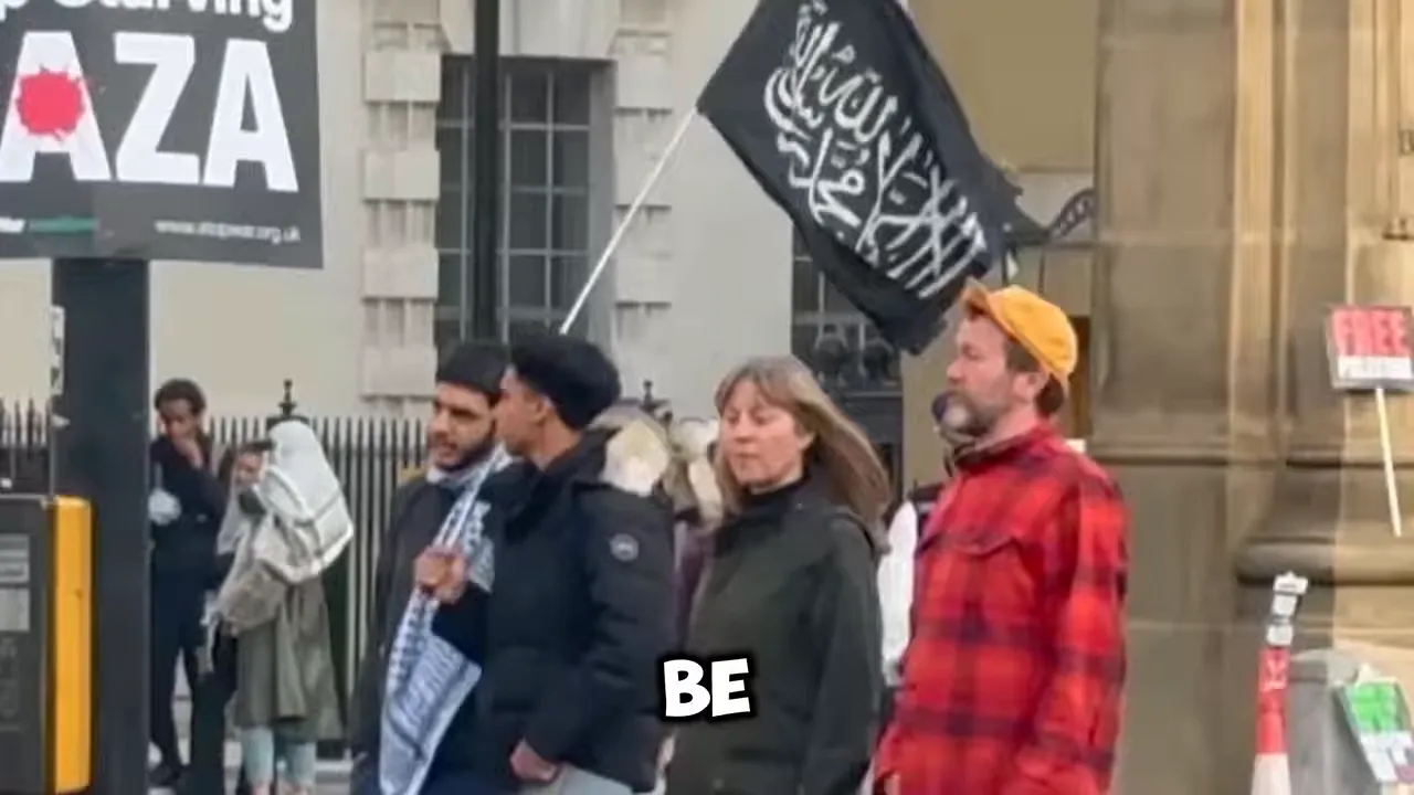 Street protest with signs including stop starving Gaza and a black flag