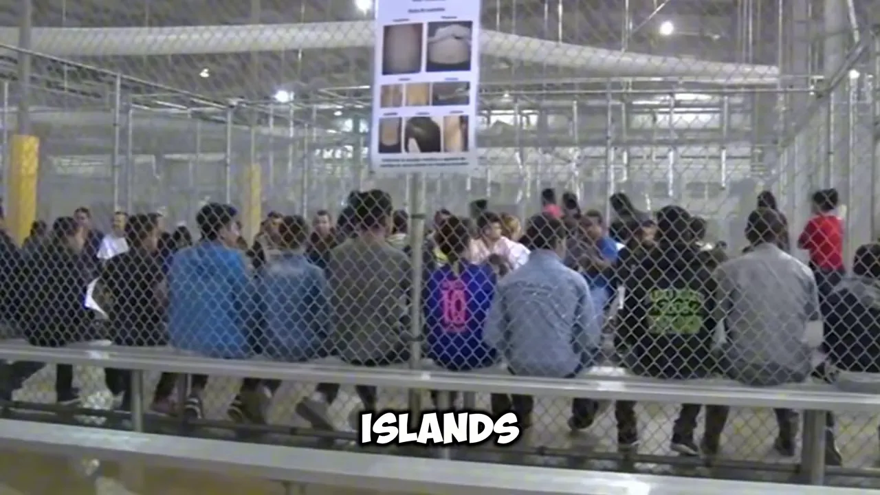 Large fenced holding area with many people seated in rows