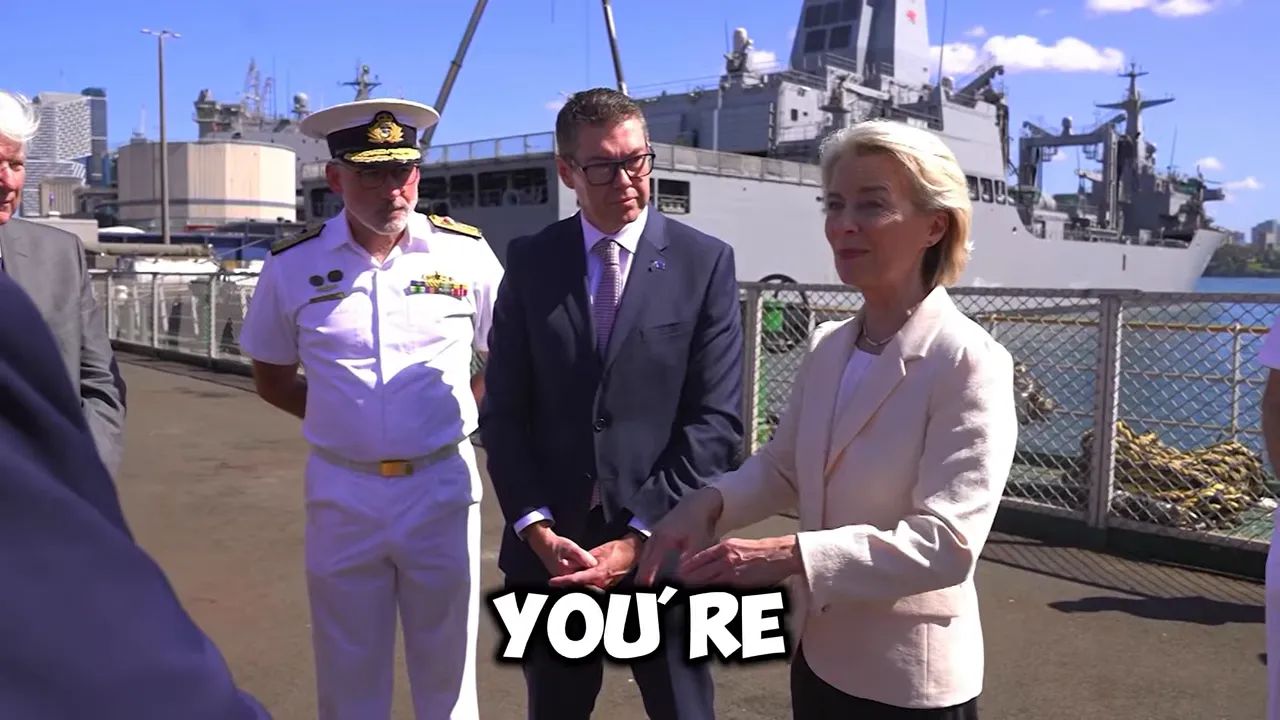 High-level officials shaking hands on a naval ship deck