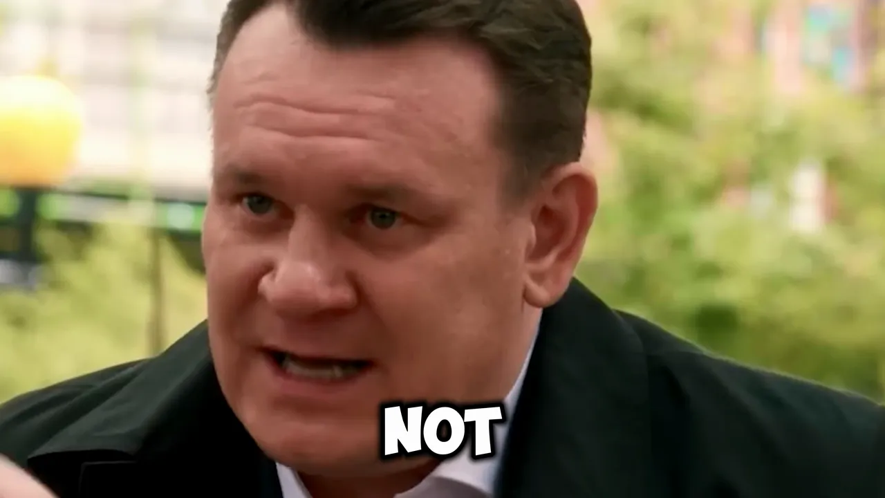 Close-up of a man speaking outdoors with short 'NOT' text overlay at the bottom