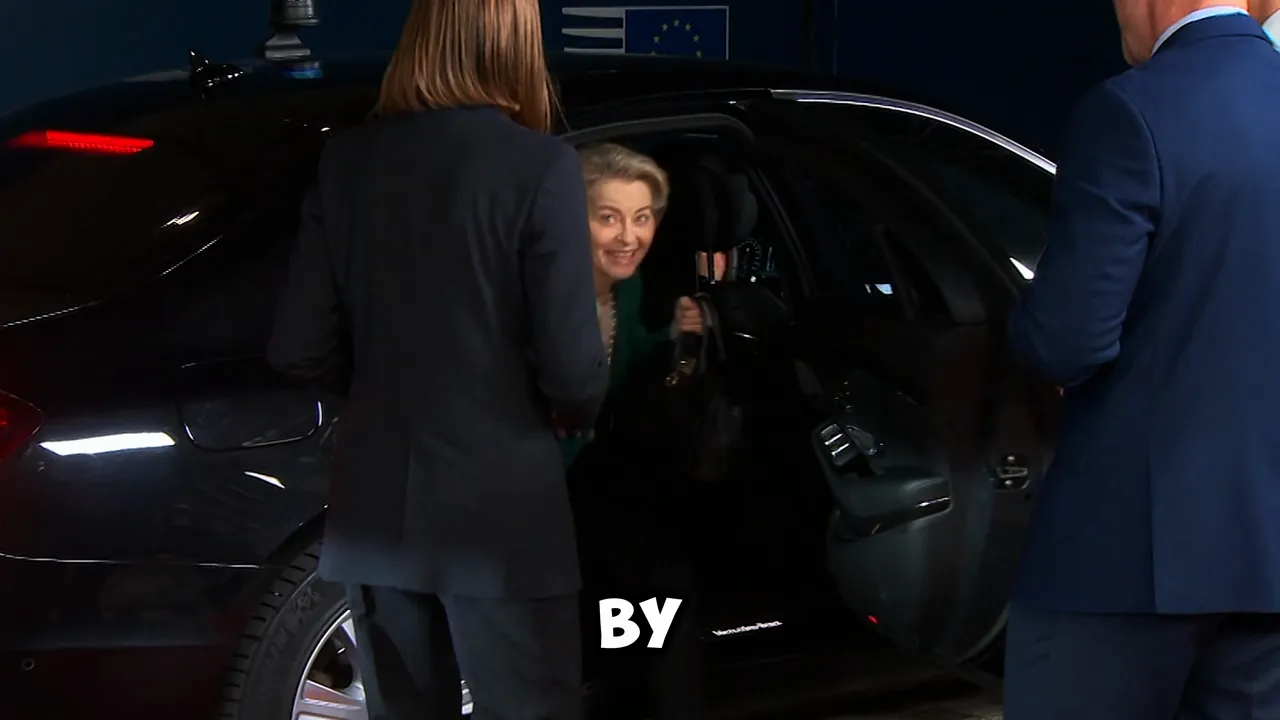 A woman exiting a car assisted by staff, with several suited officials nearby