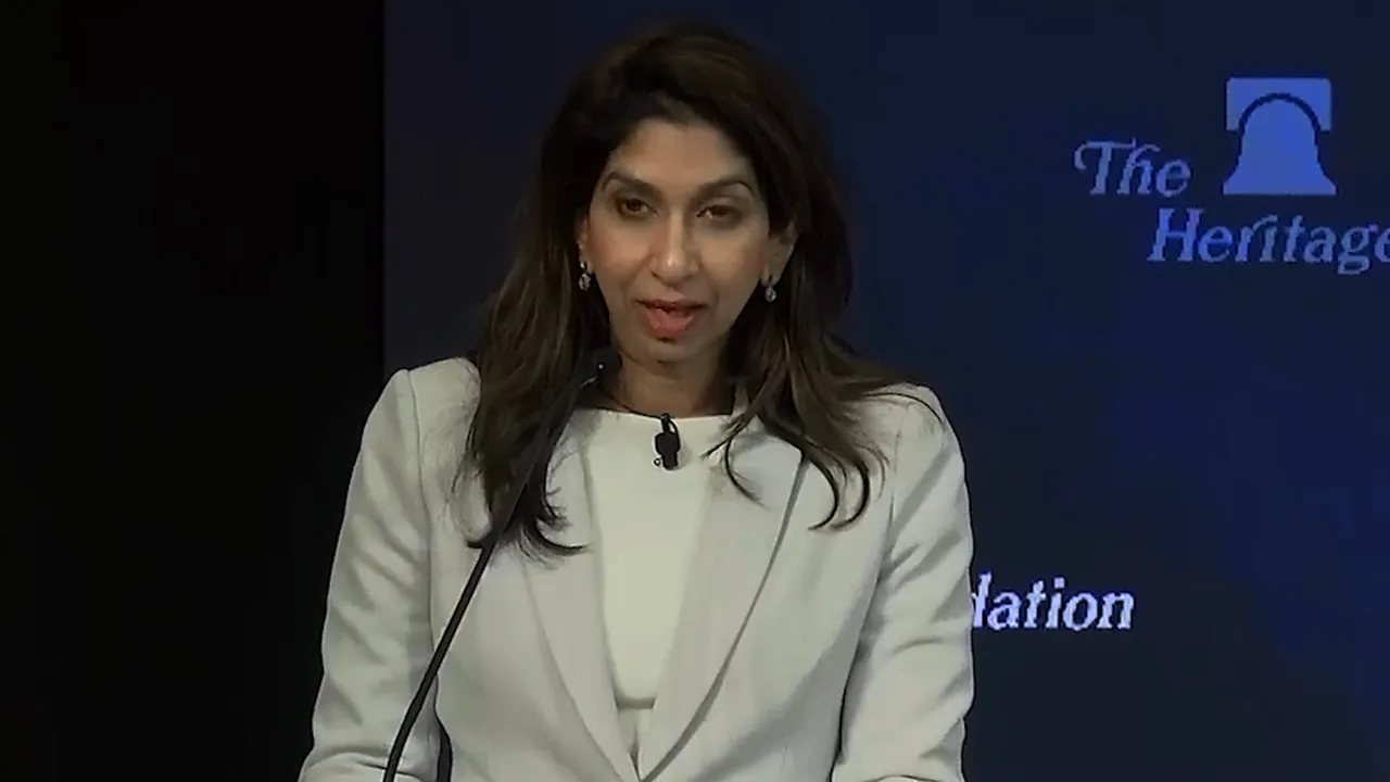 Speaker at a podium with a Heritage Foundation backdrop delivering remarks