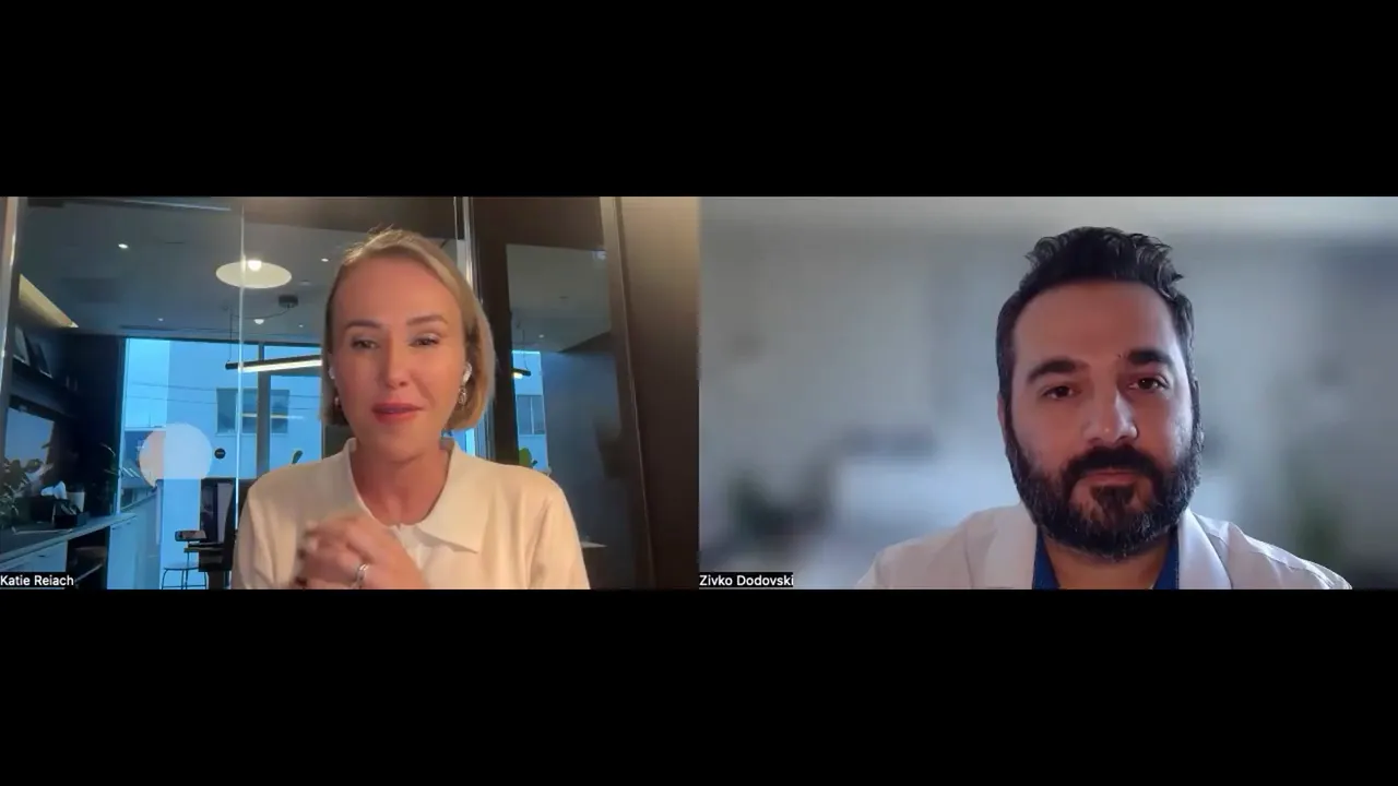 Two-person video call, clear view of both speakers discussing metrics and dashboards