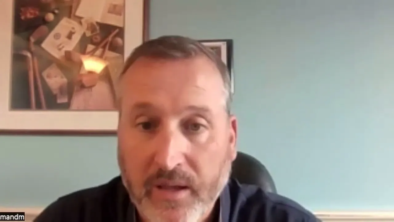 Presenter on a video call explaining surcharging and dual pricing with teal wall background