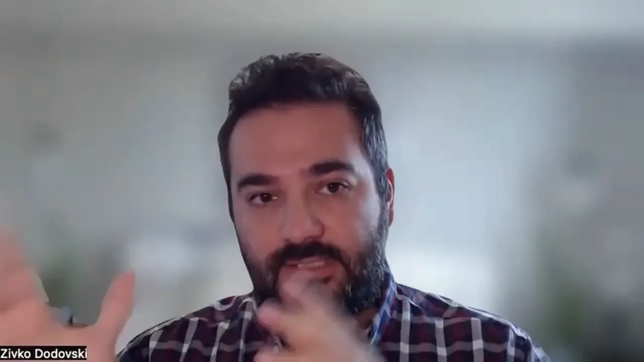 Centered, high-quality video-call screenshot of a presenter gesturing while explaining surcharging and dual pricing