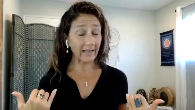 Woman speaker with eyes closed and thumbs pointing to her chest, demonstrating inward focus