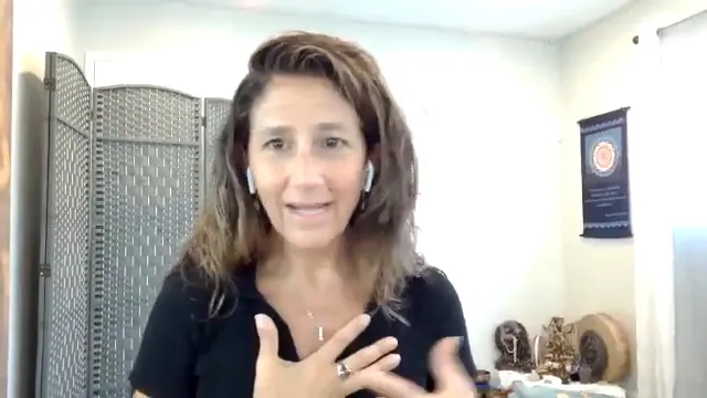 Dana Damara with one hand on her chest, speaking calmly and compassionately