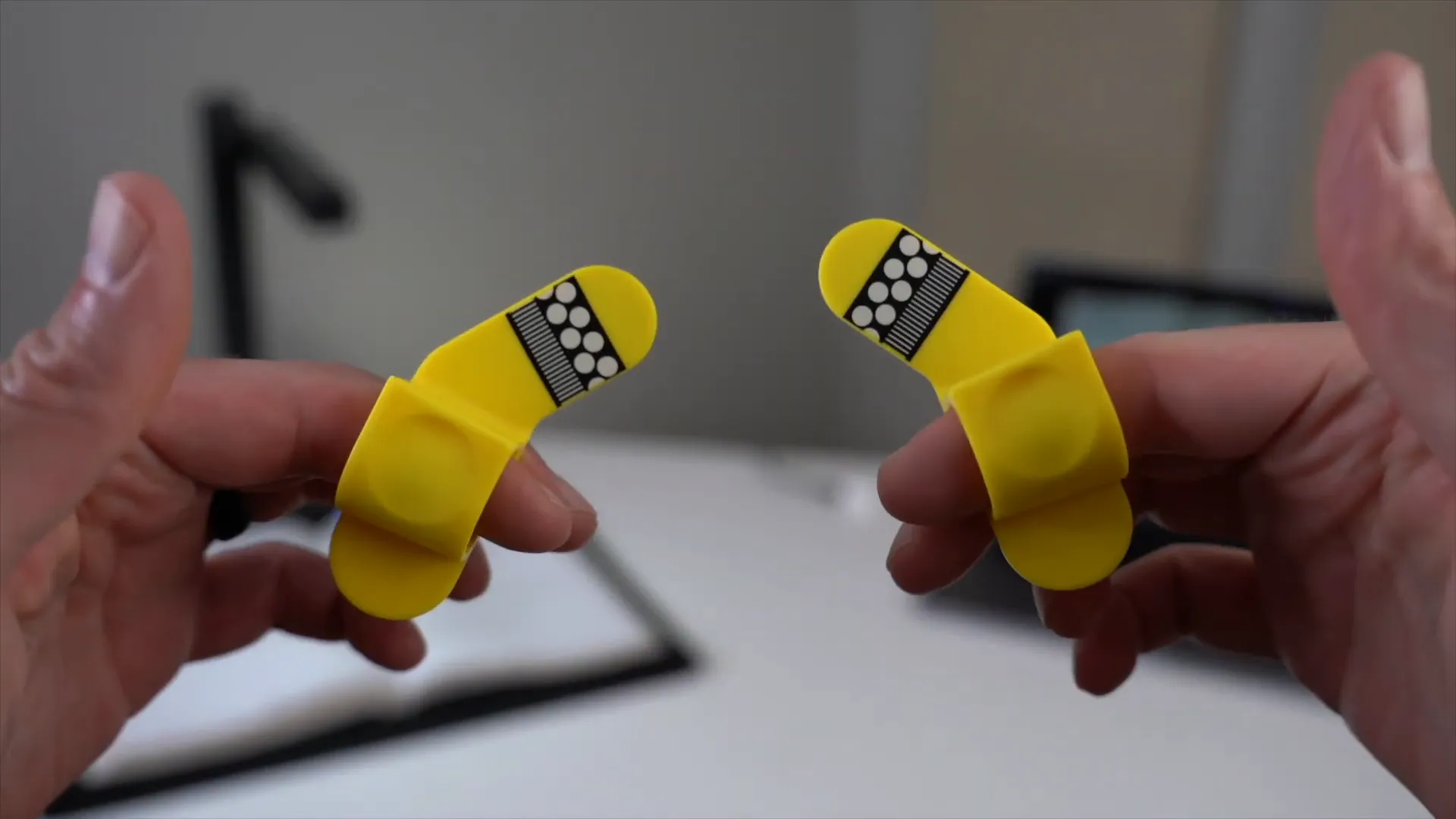 Using finger cots to hold book pages flat during scanning