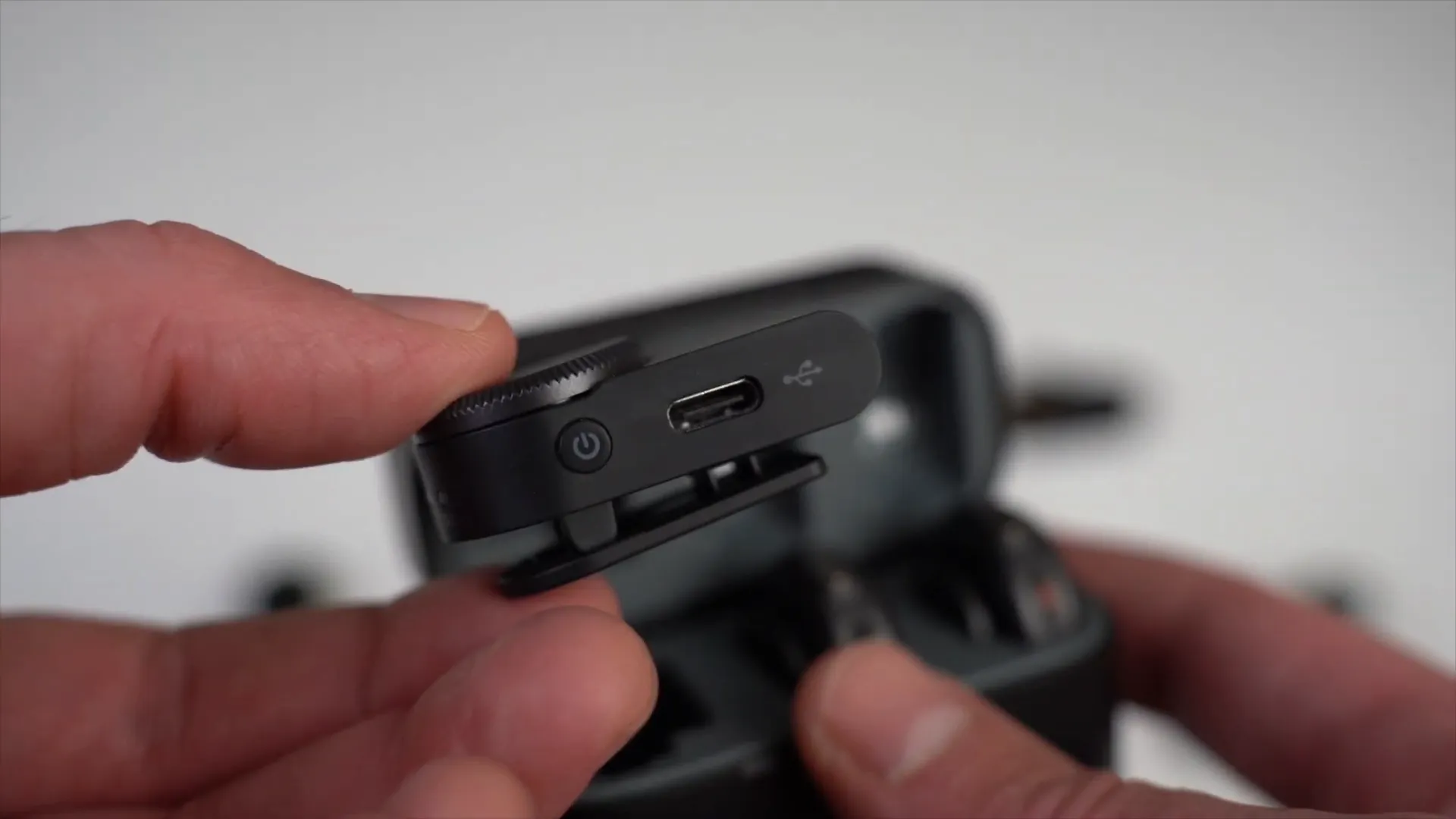 Camera receiver showing power, pairing button, and volume knob