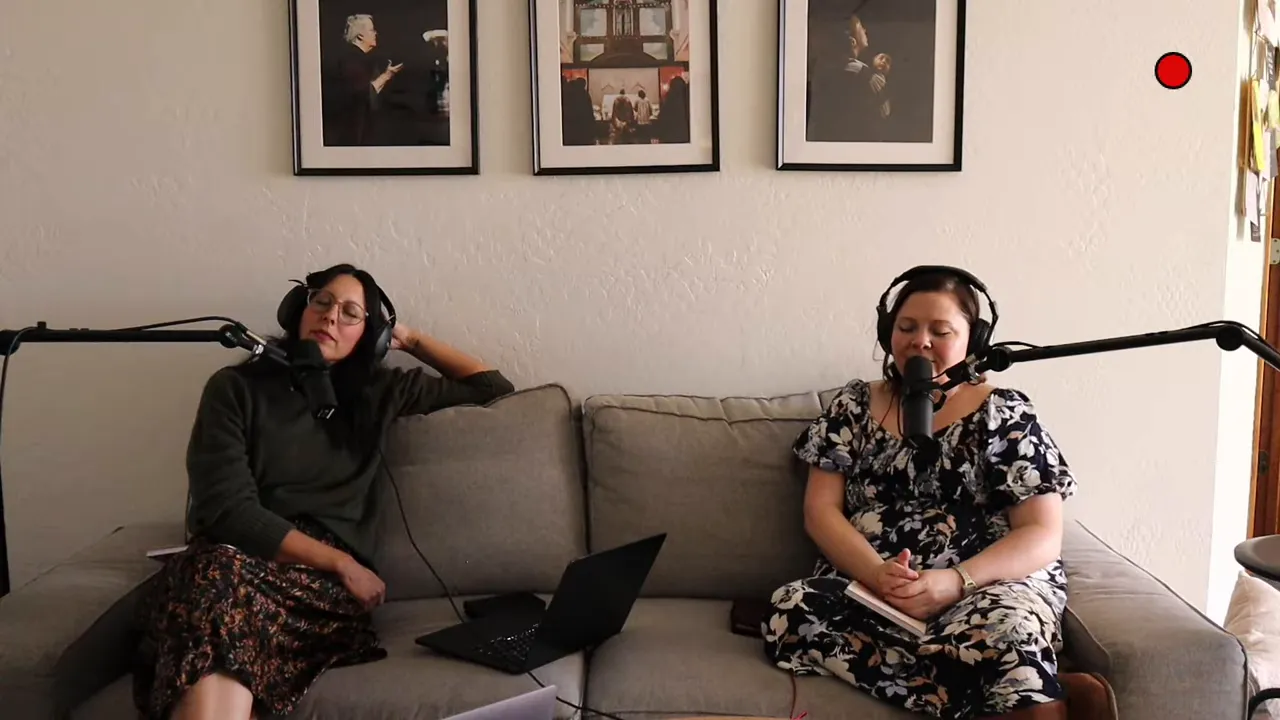 Two women on a couch in headphones with eyes closed, captured during a quiet moment of reflection
