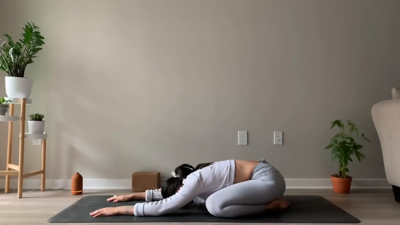 Child's Pose Twist with right arm under left arm