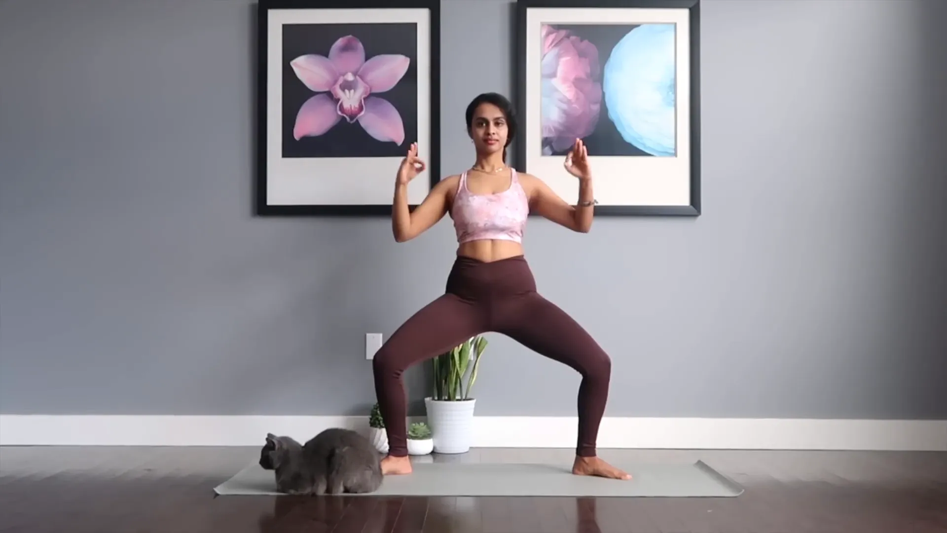 Demonstrating Goddess Pose with proper alignment